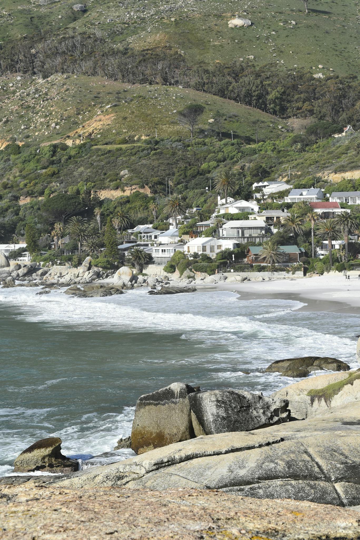 Stunning vista of Glen Beach with houses and mountain backdrop in Cape Town, South Africa.